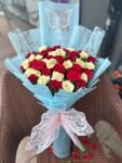 red-yellow-roses-bouquet-with-blue-wrap