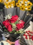 black-wrapping-red-roses-babys-breath-bouquet-flowers-studio
